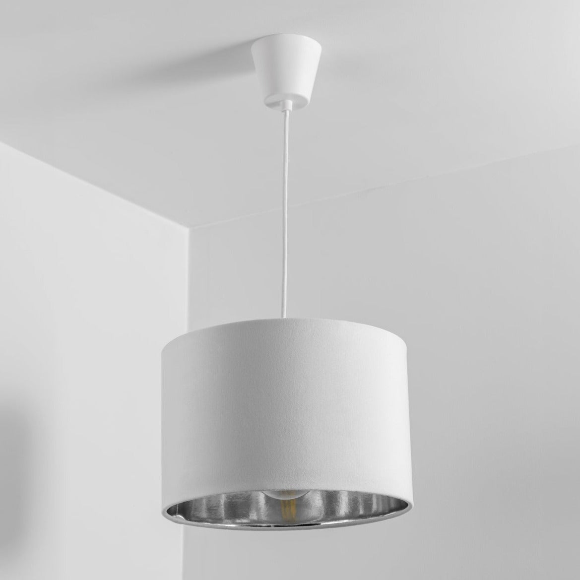 Our Nila velvet shade is sophisticated in appearance and we have designed the shade to suit a range of interiors. Easy to fit, it’s crafted from high-quality velvet on the outer and has a reflective Silver metallic inner. It's made to fit both a ceiling light or lamp base.