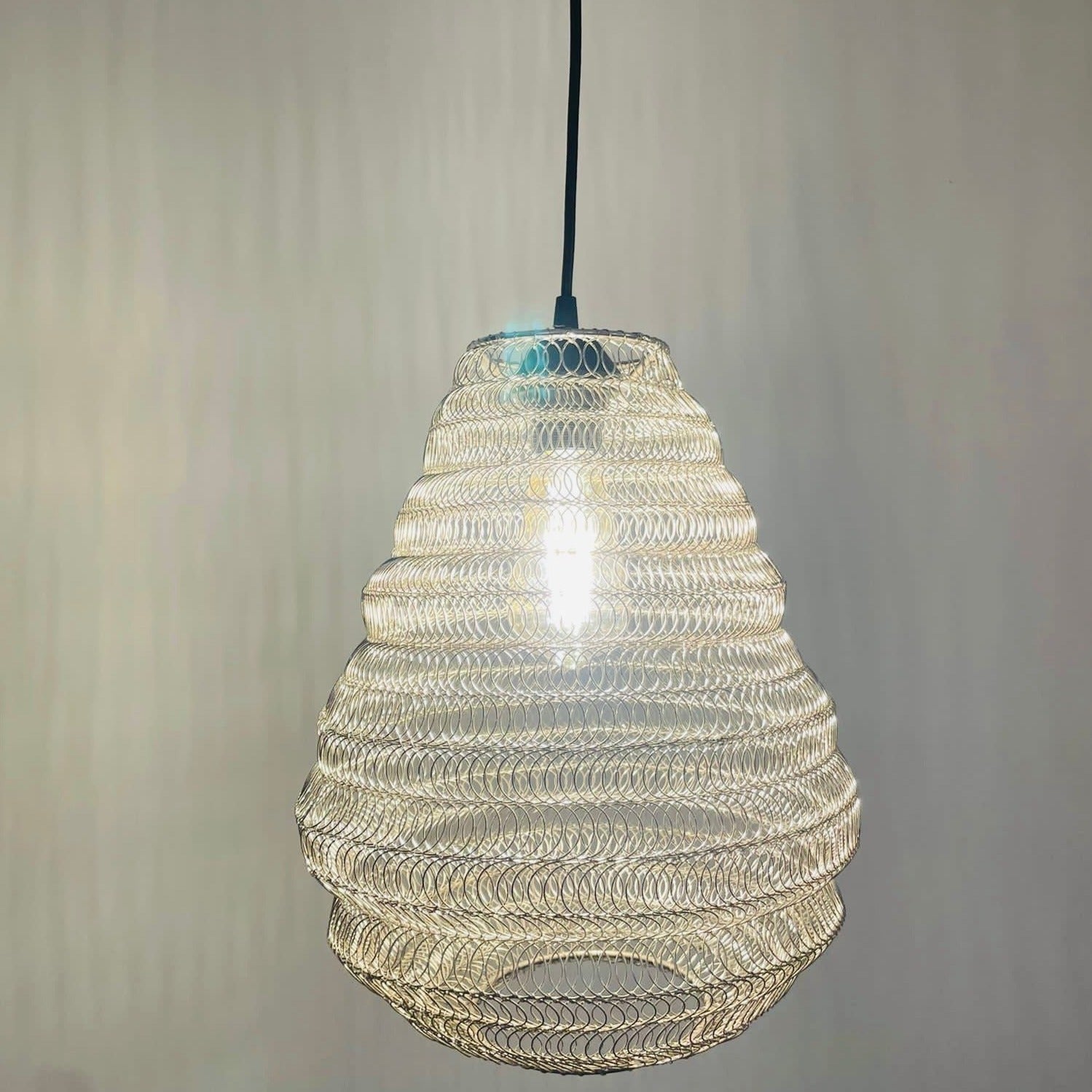 Bring a Moroccan twist to your home décor with the delicately crafted Casablanca ceiling light. Made in an intricate design from silver metal wire this large statement light would look fabulous in both living and dining spaces, as well as bedrooms. When switched on the light shines through the shade creating a spectacular pattern on the ceiling and walls.