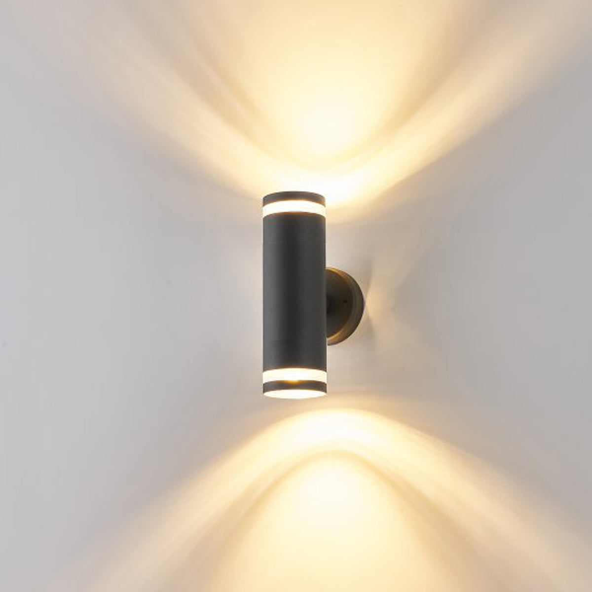 Our Jennifer black outdoor wall mounted up and down cylinder outdoor light would look perfect in a modern or more traditional home design. Outside wall lights can provide atmospheric light in your garden, at the front door or on the terrace as well as a great security solution. It is designed for durability and longevity with its robust material producing a fully weatherproof and water resistant light fitting.