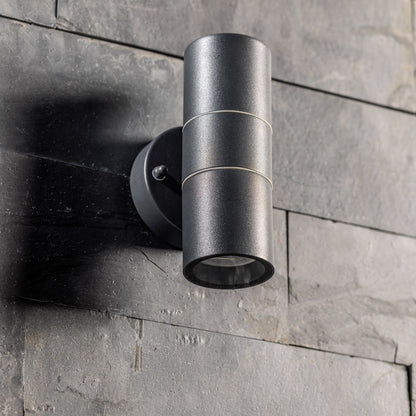 Our Mia outdoor up and down outdoor wall light is modern and stylish in its appearance.  It comes in a cylinder design mounted on a circular back plate and complete with clear glass diffusers. It is designed for durability and longevity with its robust material producing a fully weatherproof and water resistant light fitting