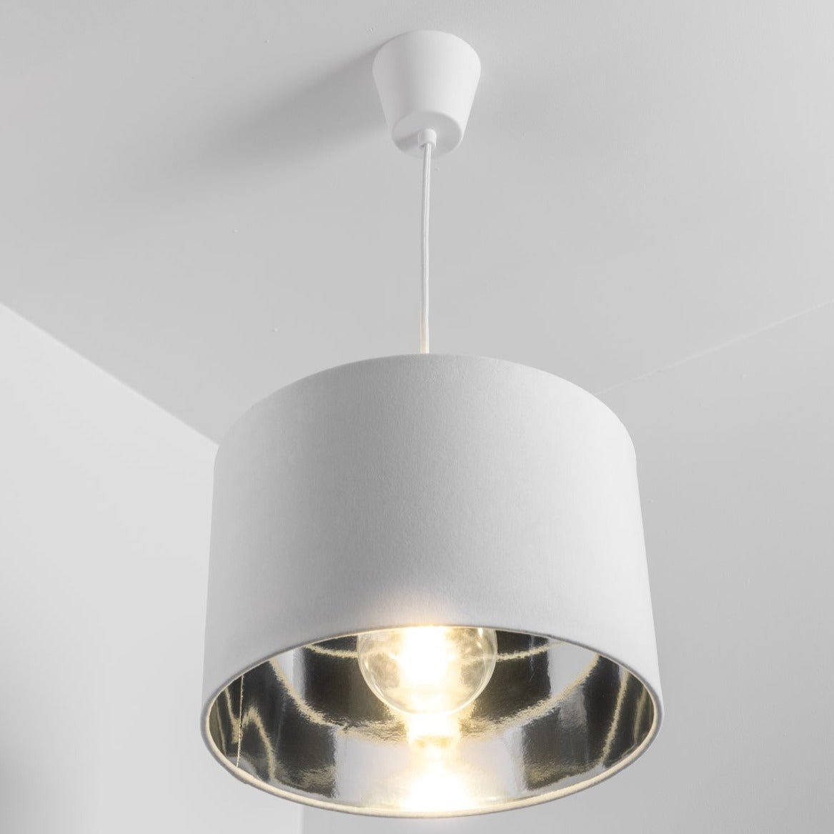 Our Nila velvet shade is sophisticated in appearance and we have designed the shade to  suit a range of interiors. Easy to fit, it’s crafted from high-quality velvet on the outer and has a reflective Silver metallic inner. It's made to fit both a ceiling light or lamp base.