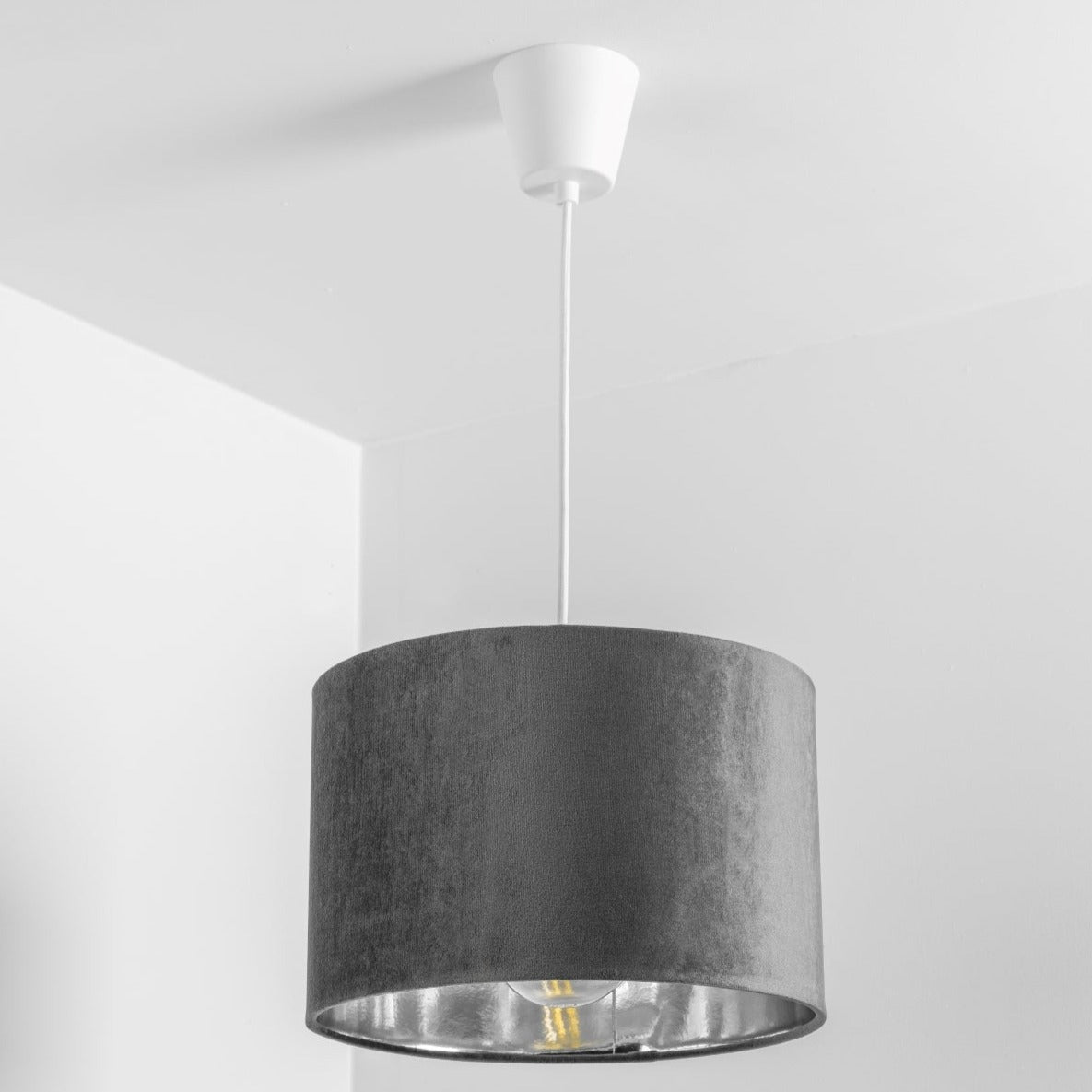 Our Nila velvet shade is sophisticated in appearance and we have designed the shade to  suit a range of interiors. Easy to fit, it’s crafted from high-quality velvet on the outer and has a reflective silver metallic inner. It's made to fit both a ceiling light or lamp base.