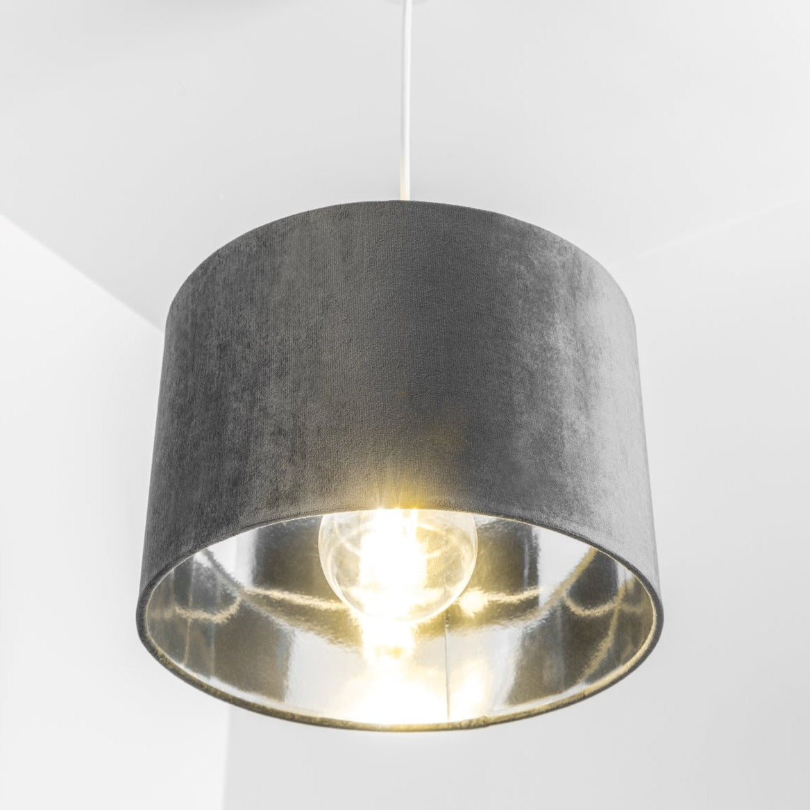 Our Nila velvet shade is sophisticated in appearance and we have designed the shade to  suit a range of interiors. Easy to fit, it’s crafted from high-quality velvet on the outer and has a reflective silver metallic inner. It's made to fit both a ceiling light or lamp base.