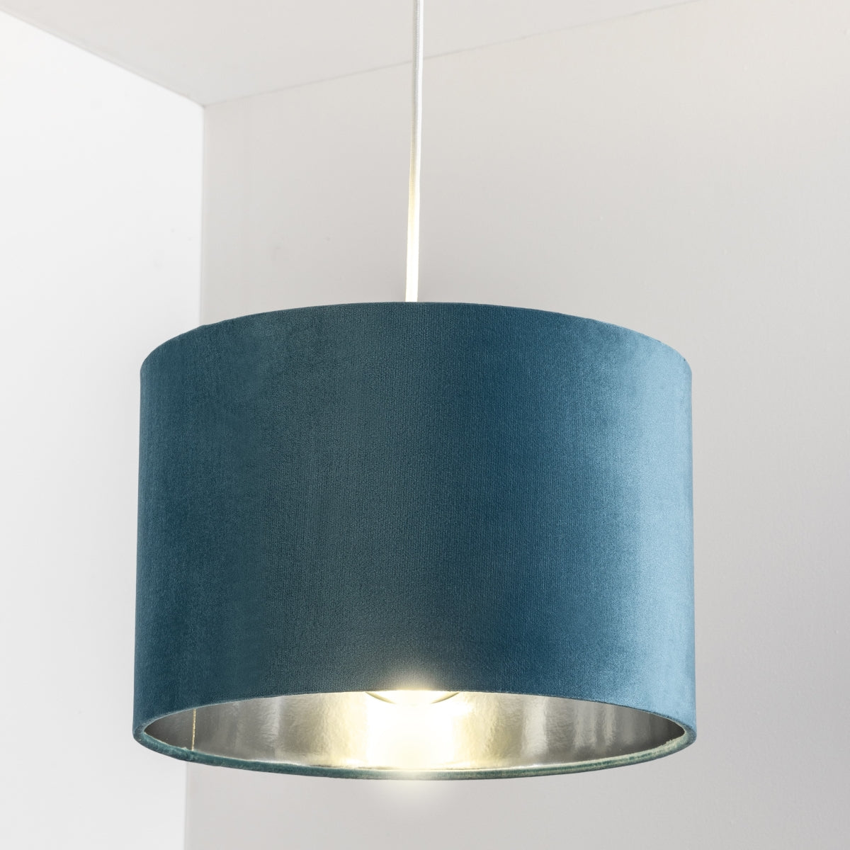 Our Nila velvet shade is sophisticated in appearance and we have designed the shade to  suit a range of interiors. Easy to fit, it’s crafted from high-quality velvet on the outer and has a reflective silver metallic inner. It's made to fit both a ceiling light or lamp base.