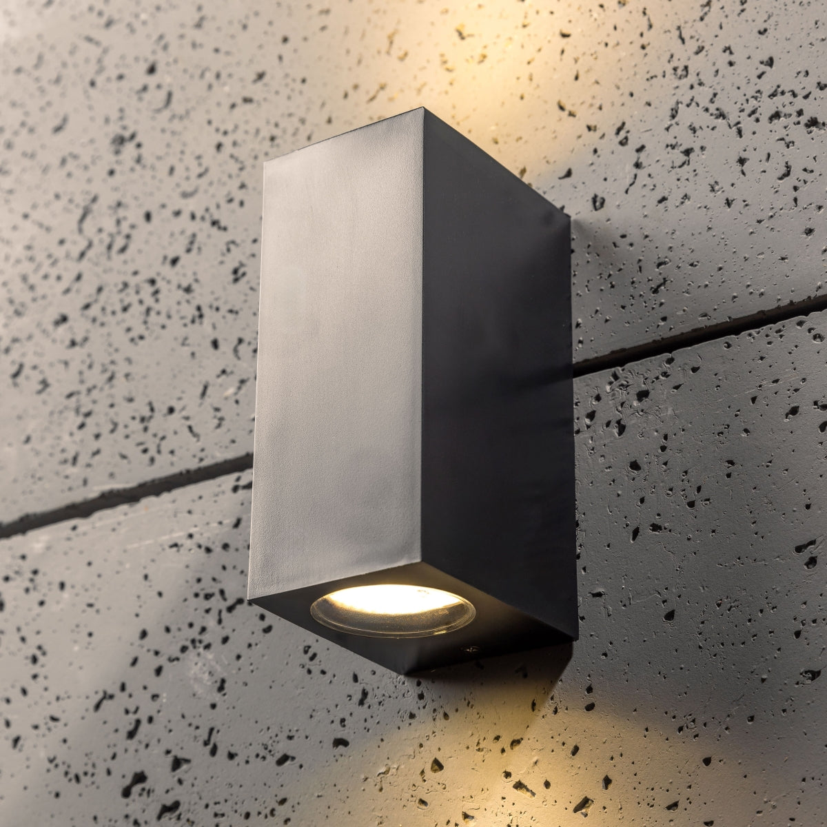 Our Eileen black up and down wall mounted rectangle outdoor light would look perfect in a modern or more traditional home design. Outside wall lights can provide atmospheric light in your garden, at the front door or on the terrace as well as a great security solution. It is designed for durability and longevity with its robust material producing a fully weatherproof and water resistant light fitting.