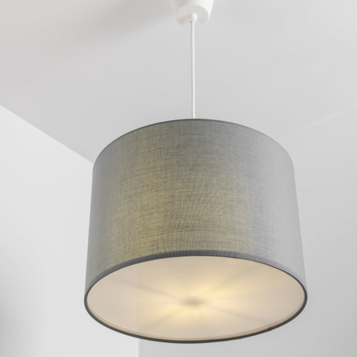 The Lucia is a modern cylinder drum shaped lamp shade in a luxury cotton finish and opal diffuser. This fantastic shade can double up as either a ceiling pendant light shade or table lampshade. Easily fits to your standard ceiling light fitting- no wiring required.