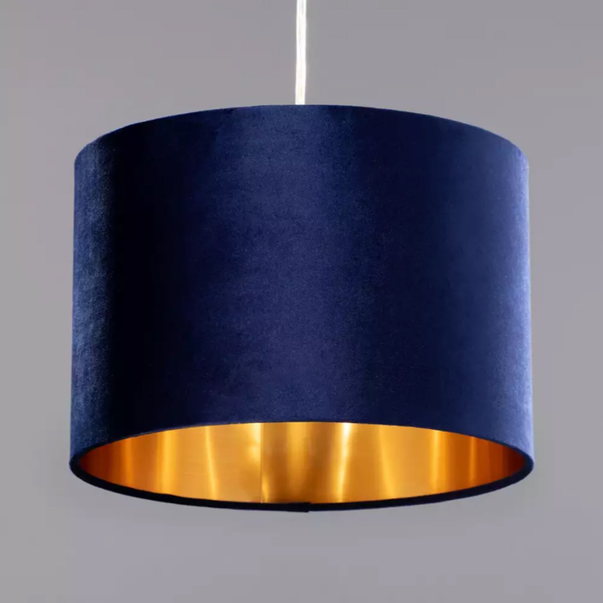 Our Nila velvet shade is sophisticated in appearance and we have designed the shade to  suit a range of interiors. Easy to fit, it’s crafted from high-quality velvet on the outer and has a reflective gold metallic inner. It's made to fit both a ceiling light or lamp base.