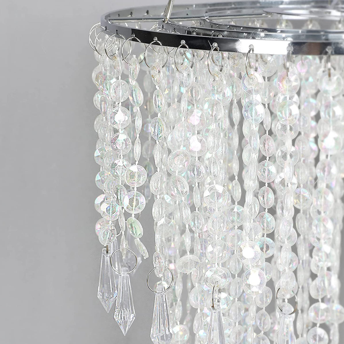 Our Liza easy fit ceiling pendant shade features polished chrome circular rings with varying lengths of acrylic crystal strands.  This beautiful easy fit pendant shade will add glamour to any space whilst instantly updating your room without the need of an electrician. 