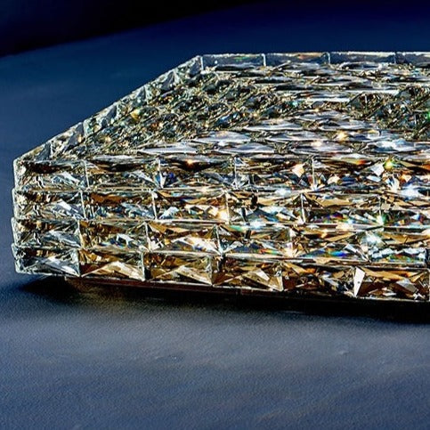 Introducing our Harmony ceiling light with its elegant crystal and golden finish it will be sure to make a stylish addition to any living space. It features an ornate cut glass crystal design encasing the entire light fitting and is complimented by a gold back plate that gives the light an undeniably luxurious style. Ceiling lamps don't come much more opulent than the Harmony ceiling light.