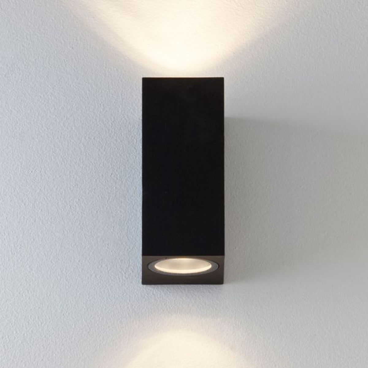 Our Eileen black up and down wall mounted rectangle outdoor light would look perfect in a modern or more traditional home design. Outside wall lights can provide atmospheric light in your garden, at the front door or on the terrace as well as a great security solution. It is designed for durability and longevity with its robust material producing a fully weatherproof and water resistant light fitting.