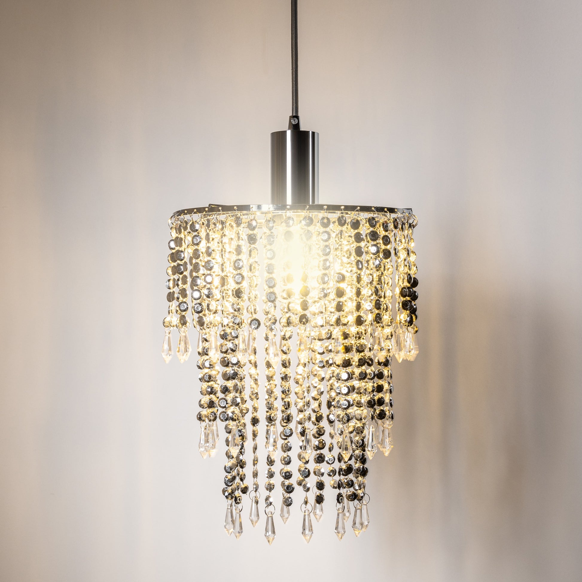 Our Liza easy fit ceiling pendant shade features polished chrome circular rings with varying lengths of acrylic crystal strands. This beautiful easy fit pendant shade will add glamour to any space whilst instantly updating your room without the need of an electrician. 